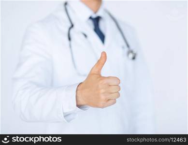 close up of male doctor hand showing thumbs up