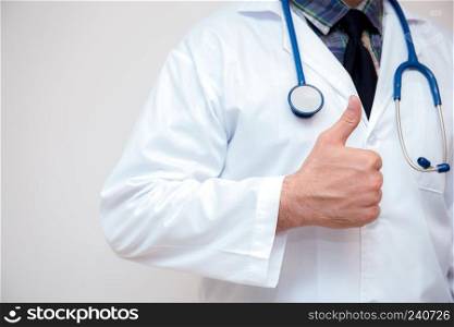 close up of male doctor hand showing thumbs up.