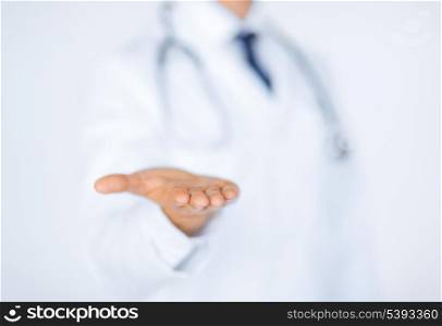close up of male doctor holding something in his hand