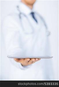 close up of male doctor holding tablet pc