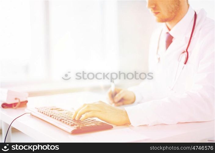 close up of male doctor typing on the keyboard. male doctor typing on the keyboard