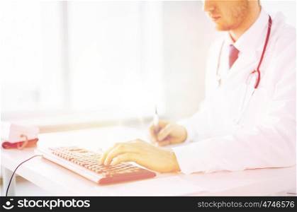 close up of male doctor typing on the keyboard. male doctor typing on the keyboard