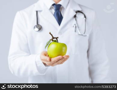 close up of male doctor with green apple