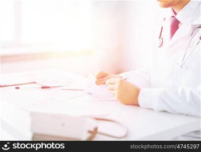 close up of male doctor writing prescription paper. male doctor writing prescription paper