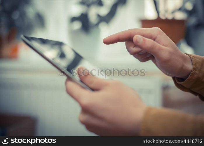 Close up of male hand using digital tablet