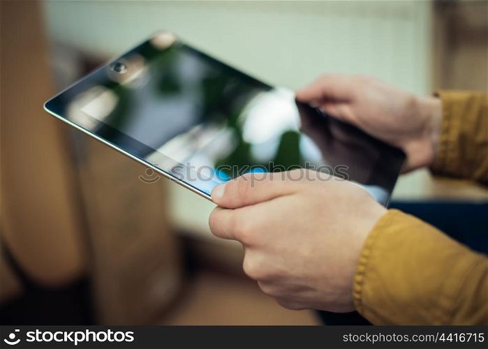 Close up of male hand using digital tablet
