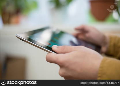 Close up of male hand using digital tablet