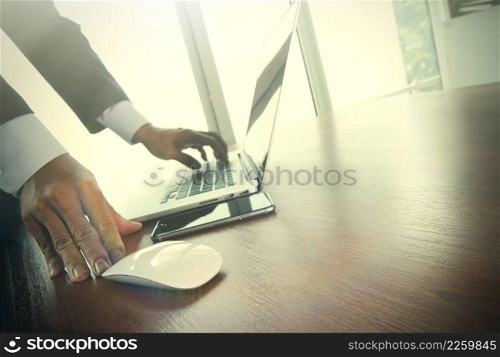 Close up of male hands on mouse and over black keyboard of laptop during typing