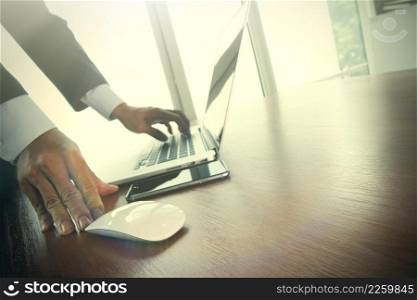 Close up of male hands on mouse and over black keyboard of laptop during typing