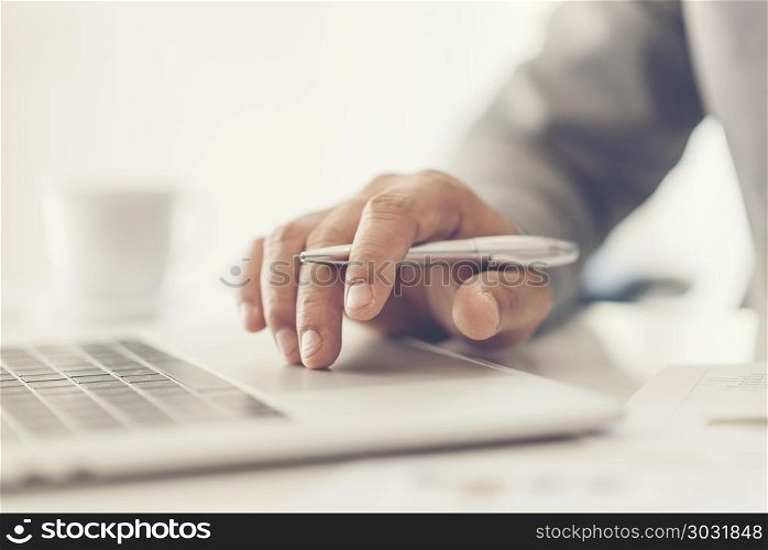 Close-up of male hands using laptop at office, man&rsquo;s hands typing on laptop keyboard in interior, side view of businessman using computer in cafe