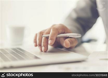 Close-up of male hands using laptop at office, man&rsquo;s hands typing on laptop keyboard in interior, side view of businessman using computer in cafe