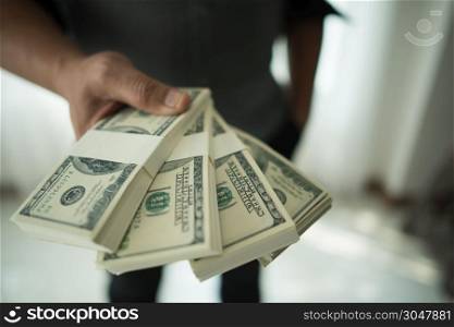 Close up of male hands with money.