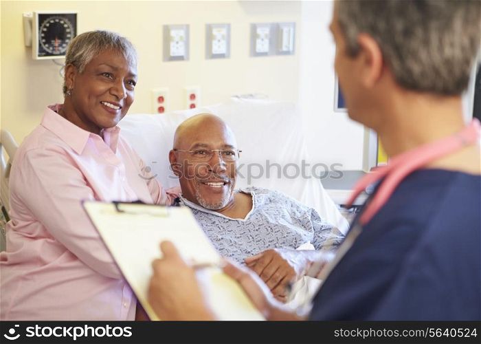 Close Up Of Male Nurse Updating Patient Notes