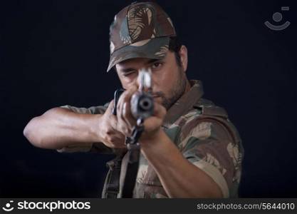 Close-up of male soldier aiming gun