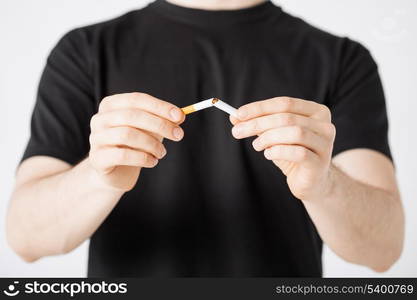 close up of man breaking the cigarette with hands