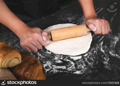 close up of man chef cooking processing dough bread bakery at a kitchen room