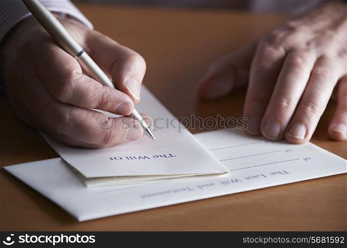 Close Up Of Man Completing Last Will And Testament