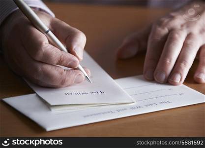 Close Up Of Man Completing Last Will And Testament