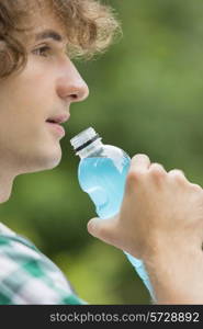 Close-up of man drinking energy drink outdoors