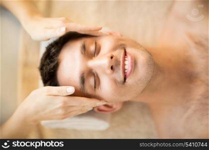 close up of man face in spa salon getting facial massage