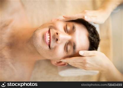 close up of man face in spa salon getting facial massage. man in spa