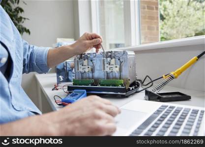 Close Up Of Man Fixing Electric Toaster Using Online Instructions Rather Than Buying New Product Sustainable Lifestyle