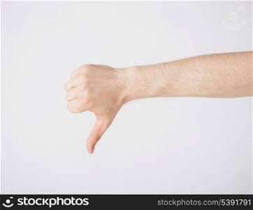 close up of man hand showing thumbs down