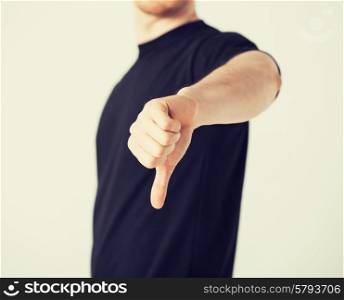 close up of man hand showing thumbs down