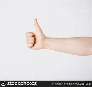 close up of man hand showing thumbs up