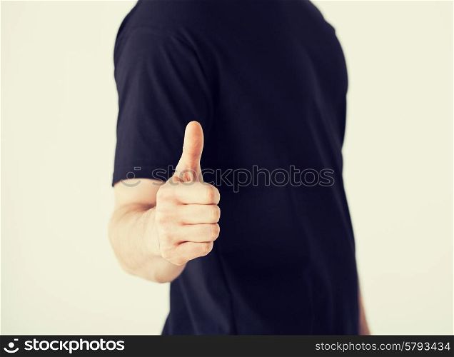 close up of man hand showing thumbs up