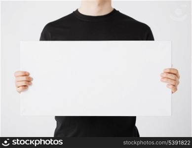 close up of man hands showing white blank board