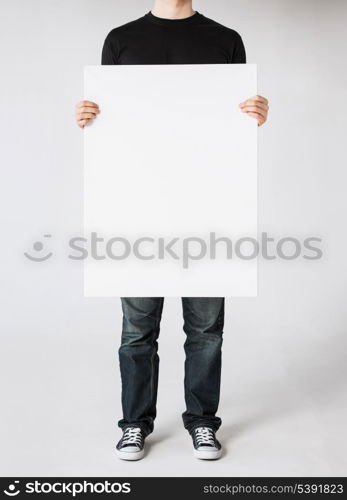 close up of man hands showing white blank board