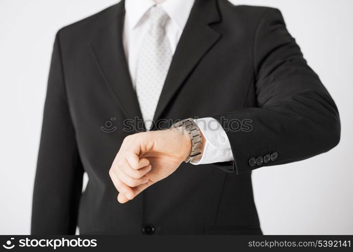 close up of man looking at wristwatch.