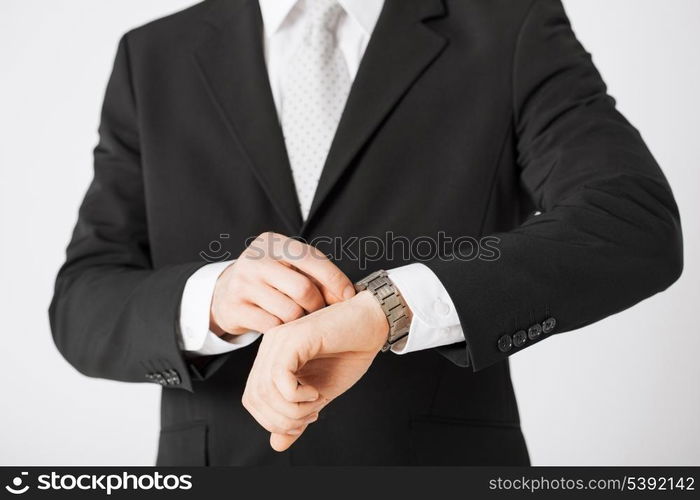 close up of man looking at wristwatch