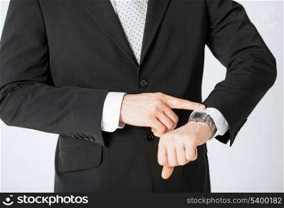 close up of man looking at wristwatch