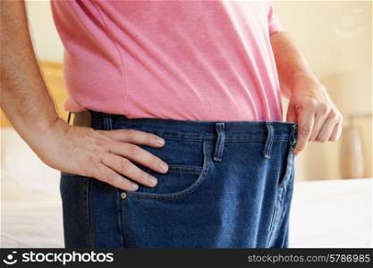 Close Up Of Man On Diet Losing Weight From Waist