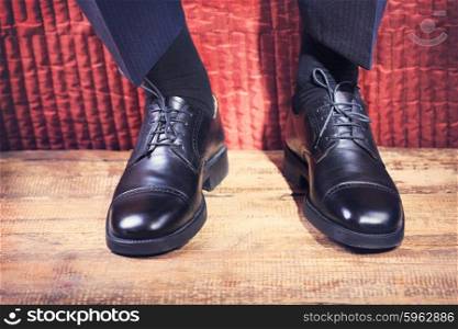 Close up of man&rsquo;s feet in a black shoes