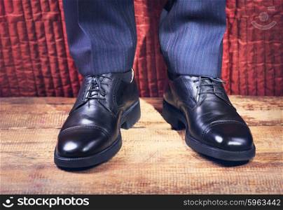 Close up of man&rsquo;s feet in a black shoes