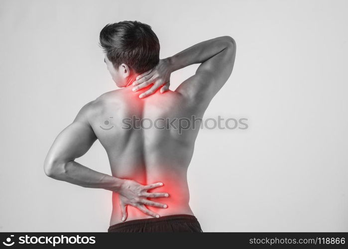 Close up of man rubbing his painful back isolated on white background.. Close up of man rubbing his painful back isolated on white backg