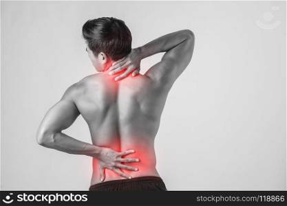 Close up of man rubbing his painful back isolated on white background.. Close up of man rubbing his painful back isolated on white backg