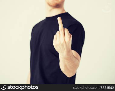 close up of man showing middle finger