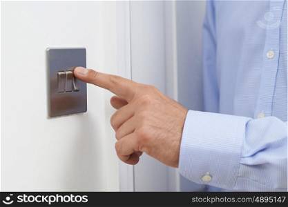 Close Up Of Man Turning Off Light Switch