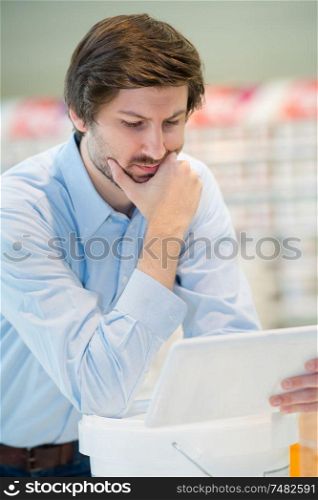 close up of man using digital tablet in shop