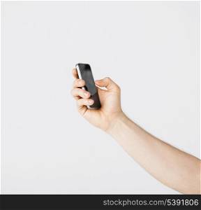 close up of man with smartphone typing something