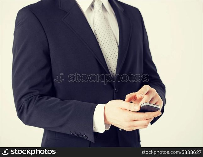 close up of man with smartphone typing something