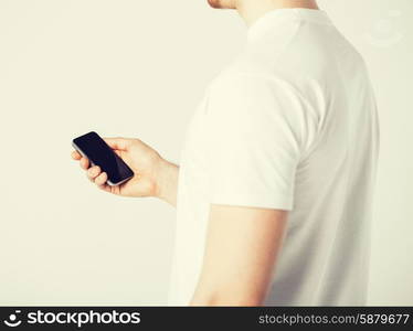 close up of man with smartphone typing something