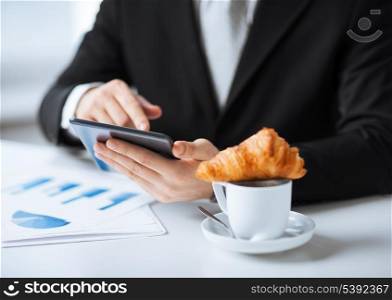 close up of man with tablet pc and cup of coffee