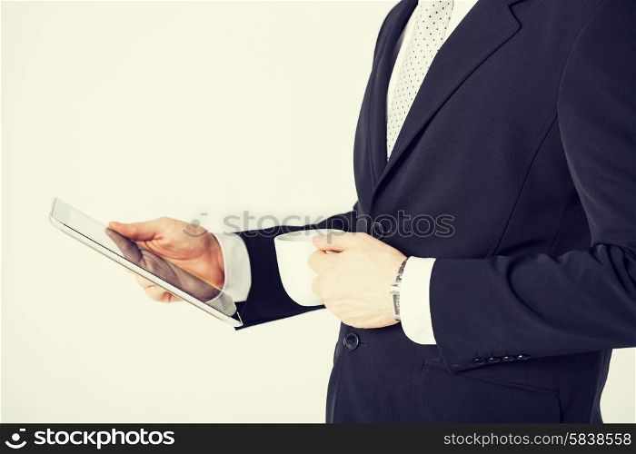 close up of man with tablet pc and cup of coffee
