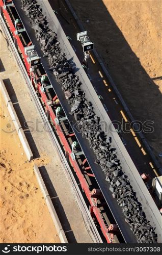 Close up of Manganese rock being moved on a conveyor belt