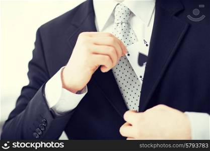close up of mans hand hiding ace in the jacket pocket